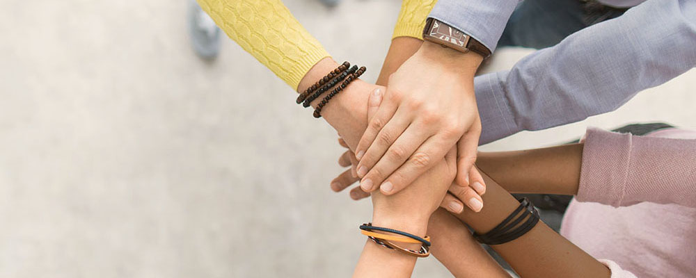 Team of People Joining Hands